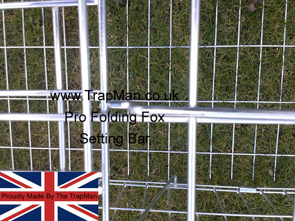 Open the door by lifting the locking bar and pushing the door up to the top of the fox cage, locate the setting bar under the very edge of the fox trap door.